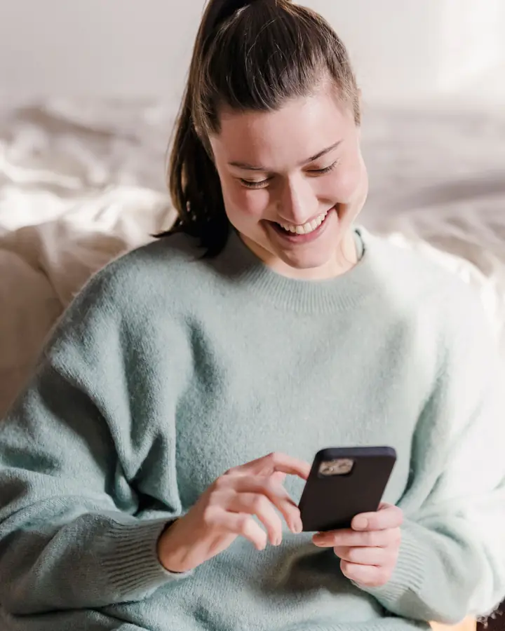 A customer holding a phone with a flower order conversation