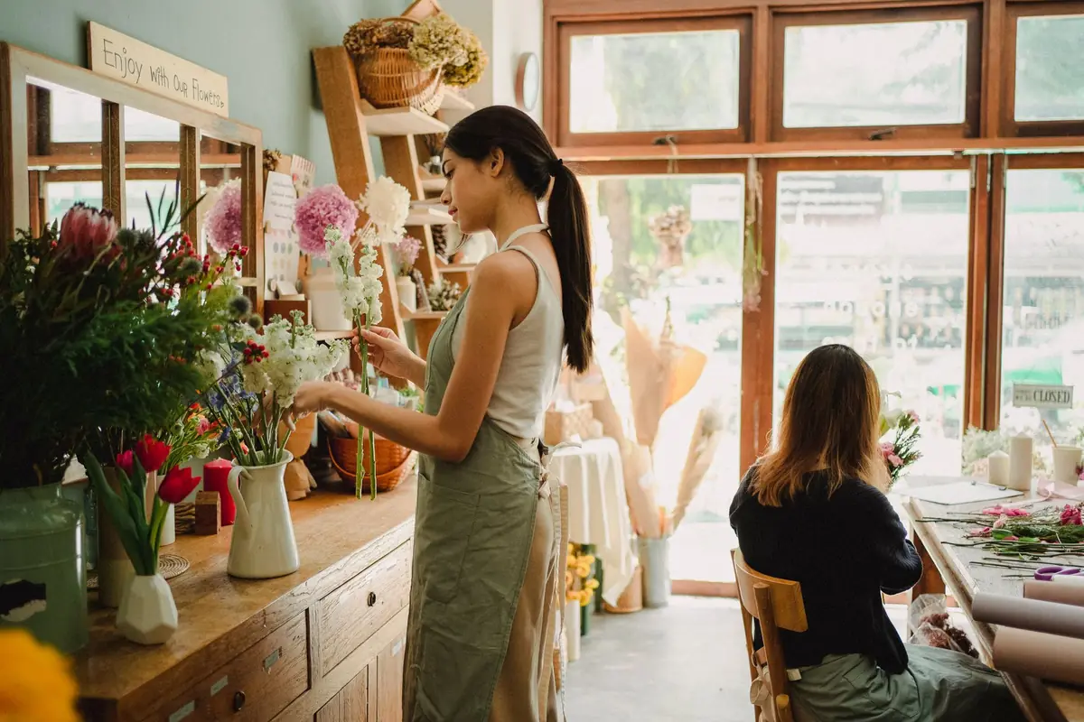 A florist arranging flowers in a bright shop